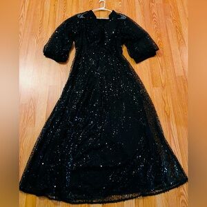 Black sequence dress with sheer sleeve.